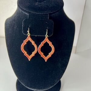 Red dangle earrings with gold tone